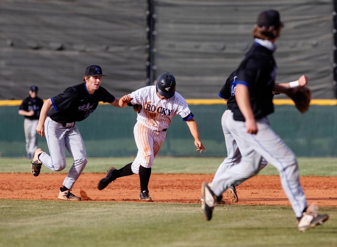 Timberline’s Logan Miller, left, tags out Rocky Mountain’s Conor Christiansen between first and second base Wednesday in Game 2 of the 5A District Three baseball championship series.