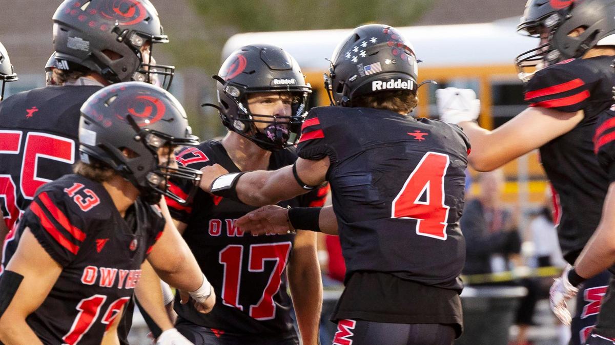 Owyhee quarterback Matt Irwin (4) celebrates with wide receiver Aidan Joye after the duo connected on a second-quarter touchdown Friday in the Storm’s 31-21 win over Borah.