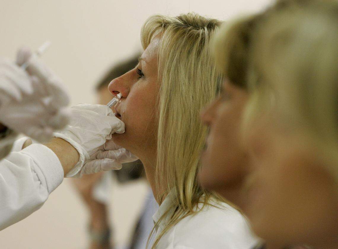 Infectious Diseases Clinical Pharmacist Sharon Erdman get a dose of the swine flu vaccine in the Occupational Health Clinic at Wishard Memorial Hospital in Indianapolis, Monday, Oct. 5, 2009. A group of Indiana health care workers was among the first in the nation to be vaccinated against the swine flu. (AP Photo/Darron Cummings)