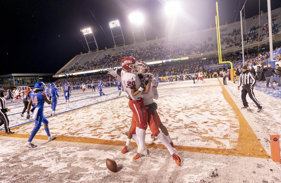 Fresno State running back Ronnie Rivers (20) celebrates with teammate Jared Rice after scoring the winning touchdown in overtime during the Mountain West championship game Saturday, Dec. 1, 2018 at Albertsons Stadium.