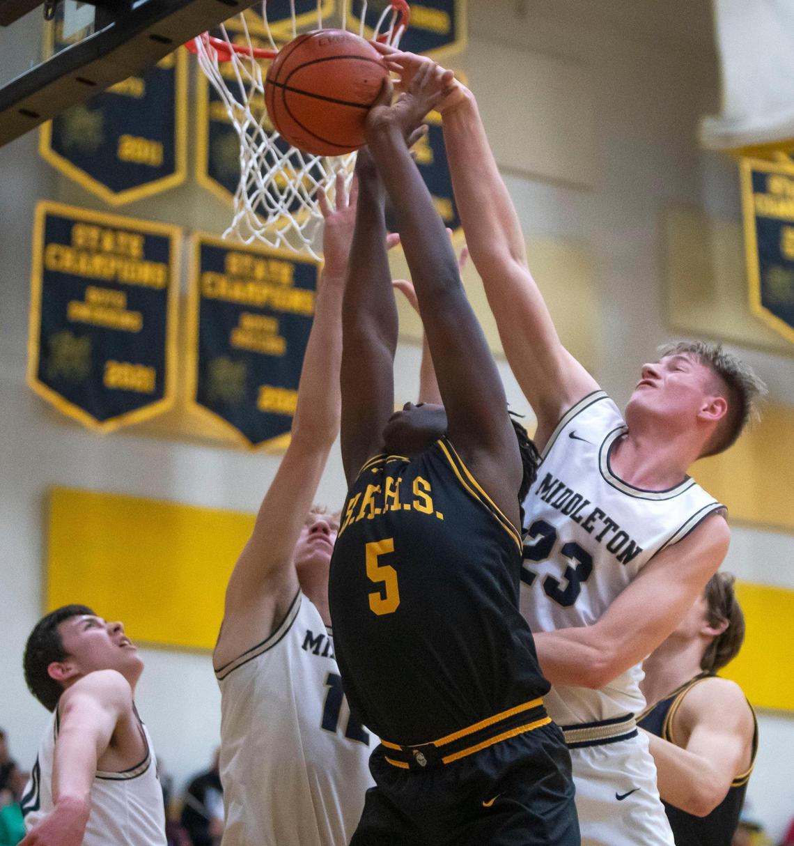 Middleton forward Michael Day, right, blocks a shot by Bishop Kelly’s Rakeem Johnson on Jan. 7 at Bishop Kelly High.