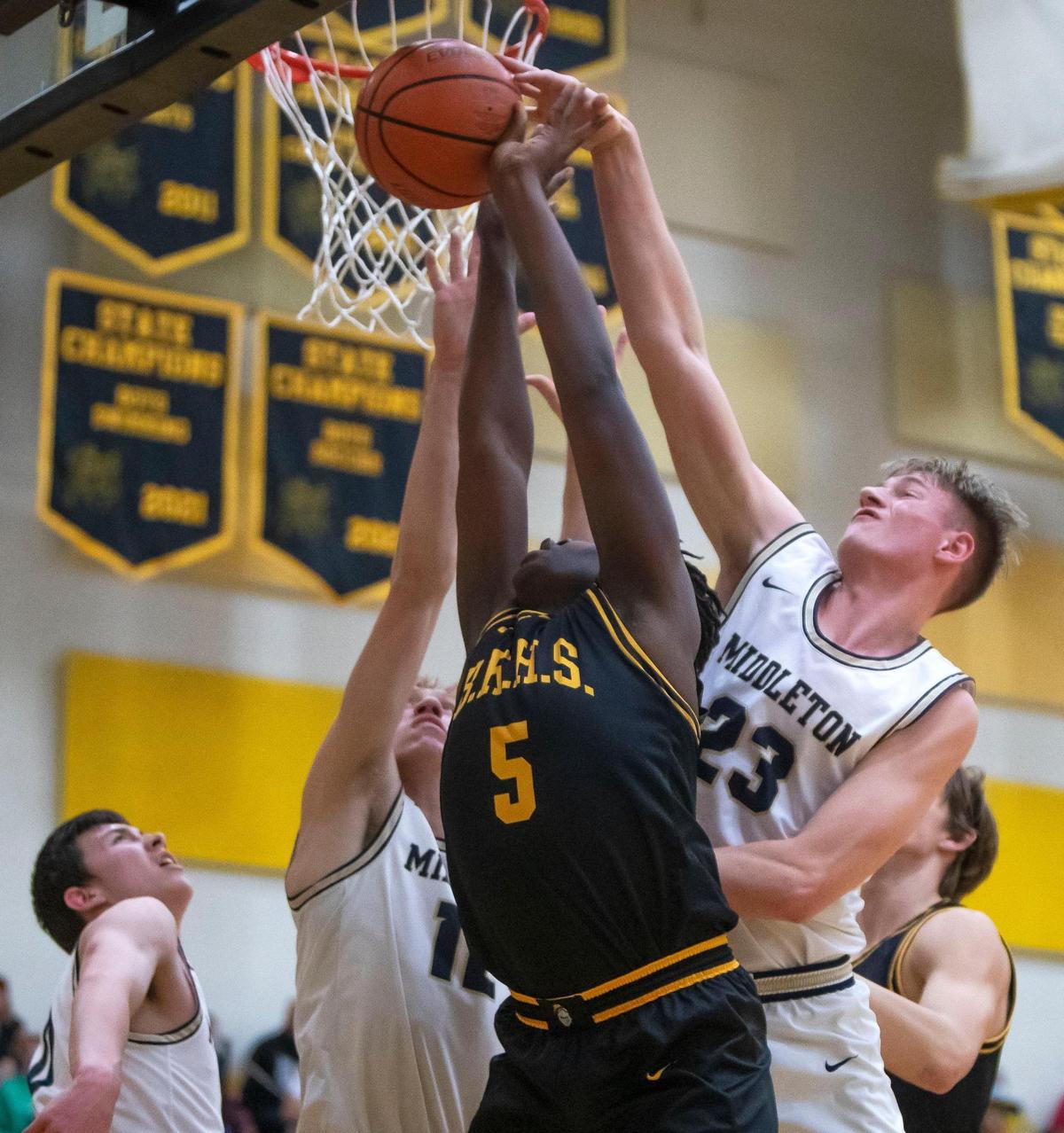 Middleton forward Michael Day blocks a shot by Bishop Kelly’s Rakeem Johnson on Friday.