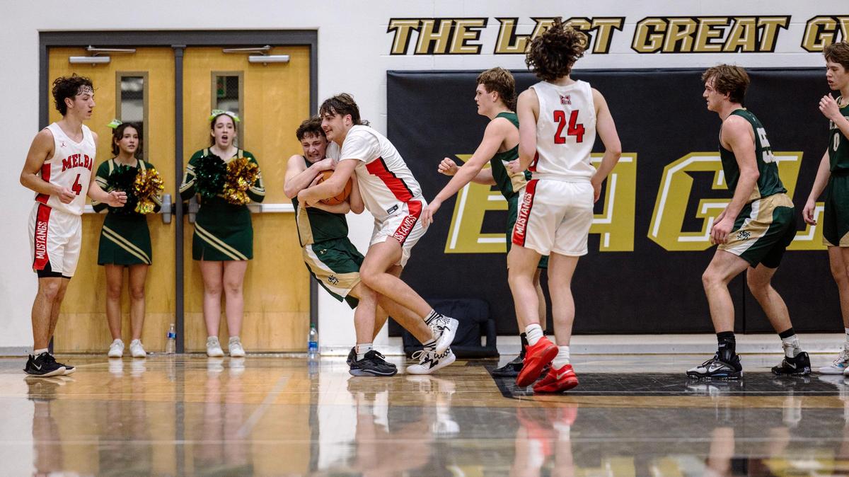 In the final seconds of the game St. Maries senior Trace Wicks and Melba junior Cache Bues fight for control of the ball after a missed shot from St. Maries during the 2A boys basketball state tournament semifinals at Capital High School, Friday, March 3, 2023. Melba won 62-58.