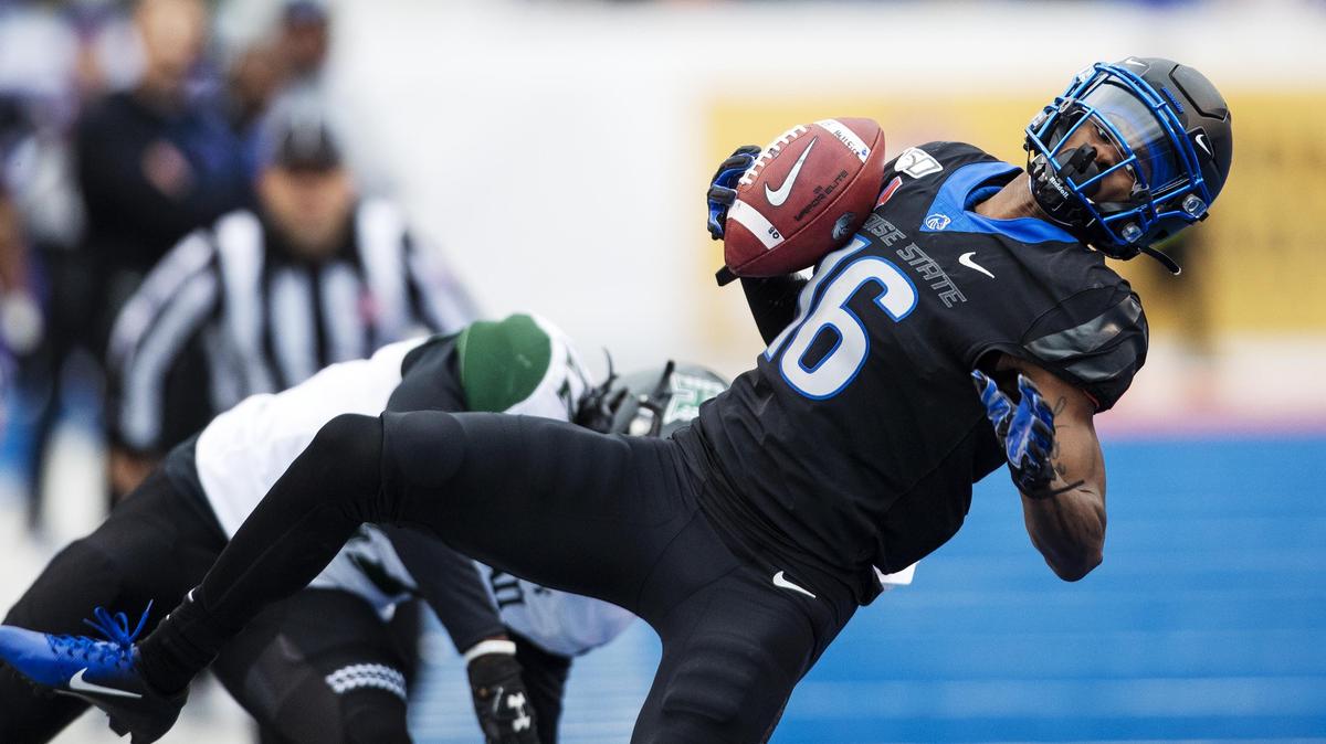 Boise State wide receiver John Hightower holds onto a reception after being hit by Hawaii defensive back Ikem Okeke and then runs for a 36-yard touchdown at the end of the first half of the Mountain West championship on Saturday, Dec. 7, 2019, at Albertsons Stadium in Boise.