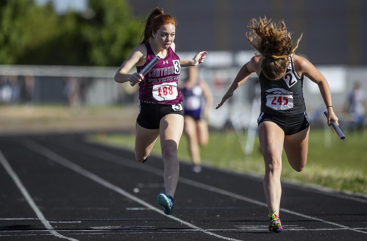 Eagle’s Aimee Peery lunges for the win against Centennial’s Cheyanne Rede in the 4x200 relay during the 5A District Three track and field championships Friday, May 10, 2019, at Centennial High in Boise. Eagle’s relay team finished in 1:43.86 to Centennial’s 1:43.97.