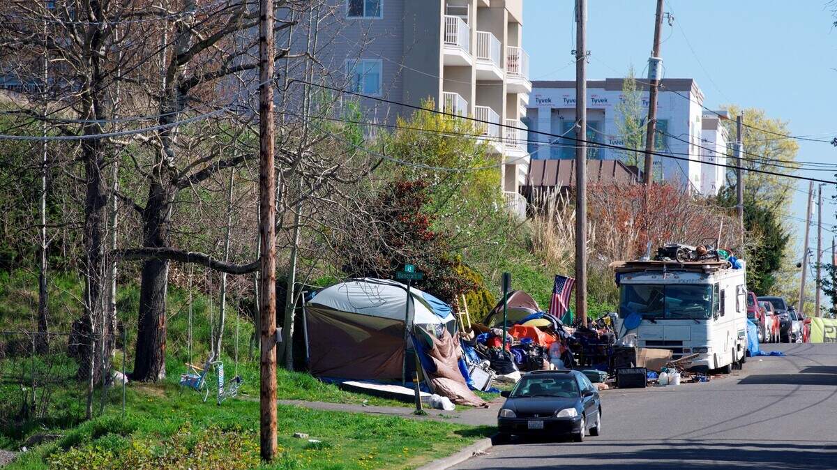 Recreational vehicles and tents line the north side of C Street on Wednesday, April 21, 2021, in downtown Bellingham, Wash.