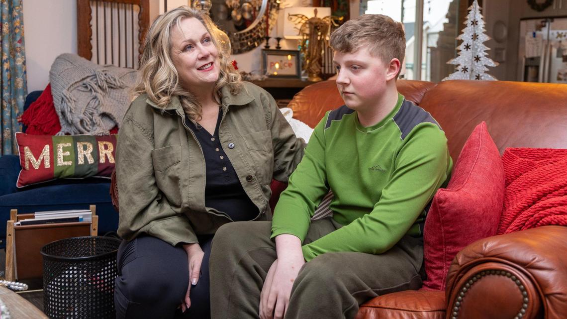 Leslie Montgomery sits with her son Elijah, 14, who she said has been having health problems from mold and an improperly installed HVAC system in their newly built home in Caldwell.