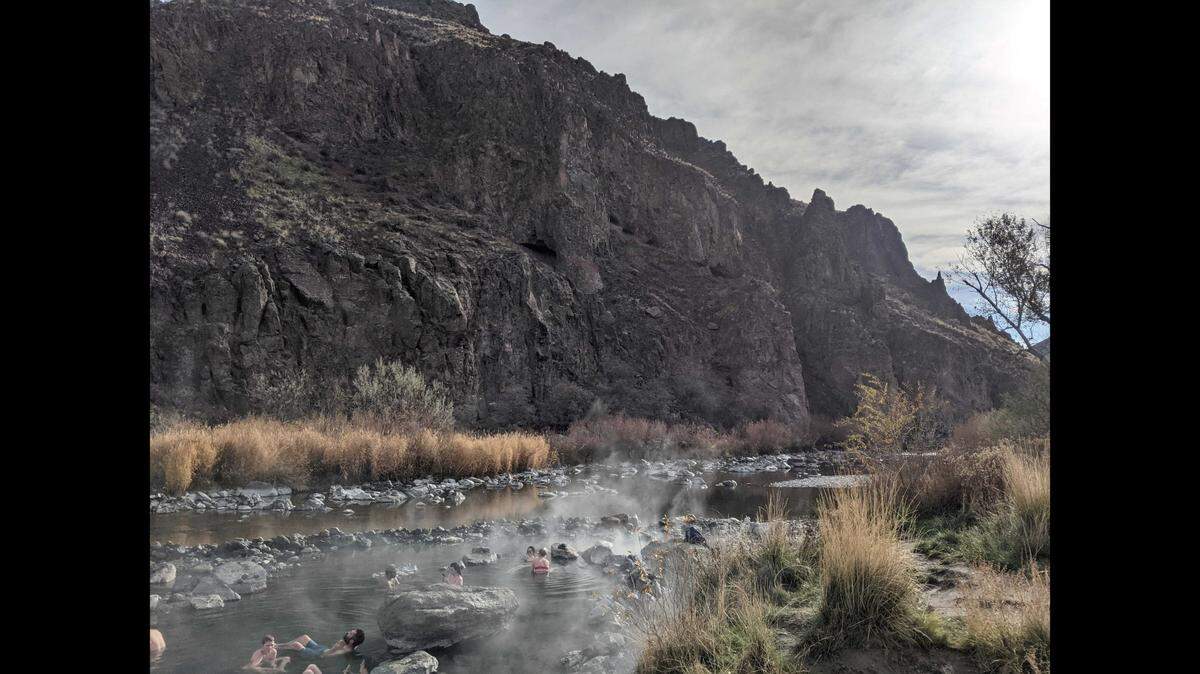 People soak in warm water at Snively Hot Springs near the Idaho-Oregon border.