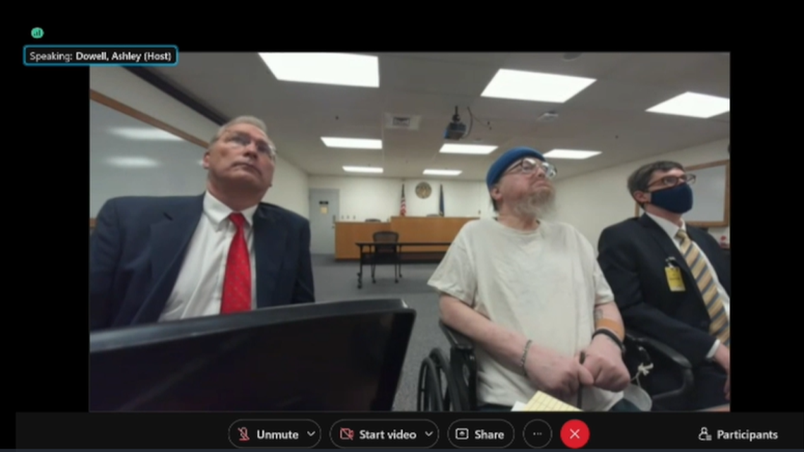 Idaho death row inmate Gerald Pizzuto, center, attends his clemency hearing on Tuesday, Nov. 30, 2021. Bruce Livingston, left, one of Pizzuto’s attorneys with the nonprofit Federal Defender Services of Idaho, sits at his left, with other members of his team also on hand.