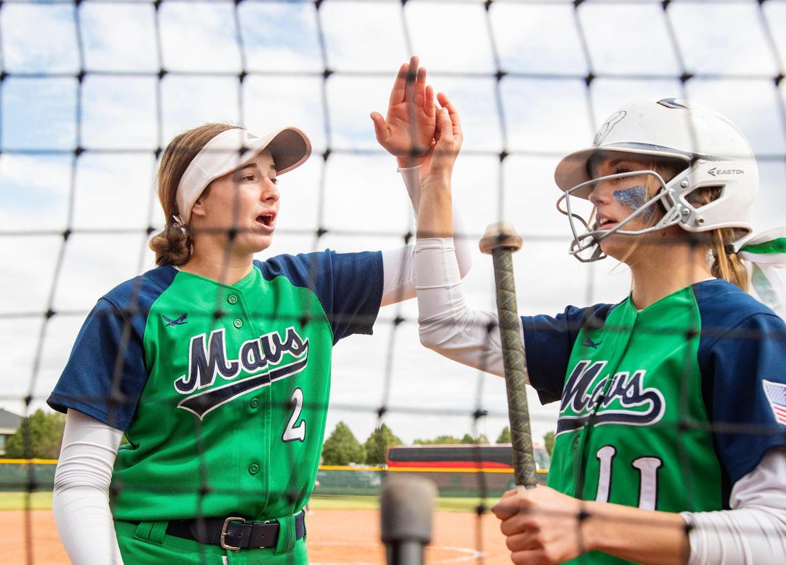 Mountain View’s Gracie Tentinger (2) gives Kourtney Goza (11) a high-five for scoring a run Friday in the 5A state tournament at Mountain View High School.