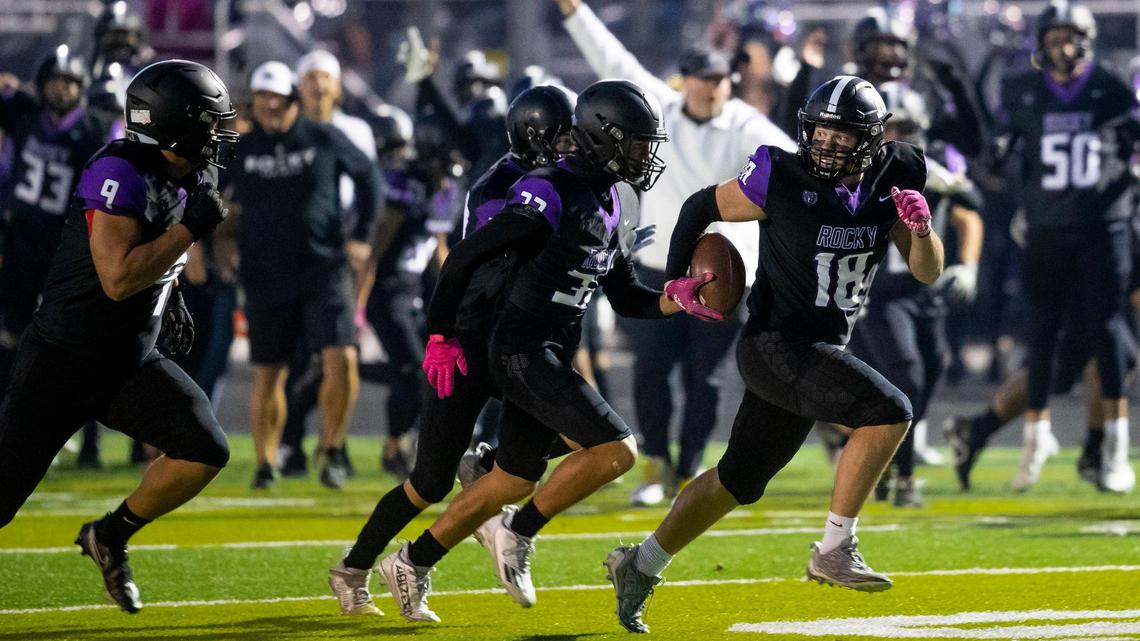 Rocky Mountain defensive lineman Parker Weatherly runs for a touchdown after scooping up a Kuna fumble early in the first quarter in the first round of the 5A state football playoffs Friday at Rocky Mountain High School in Meridian.