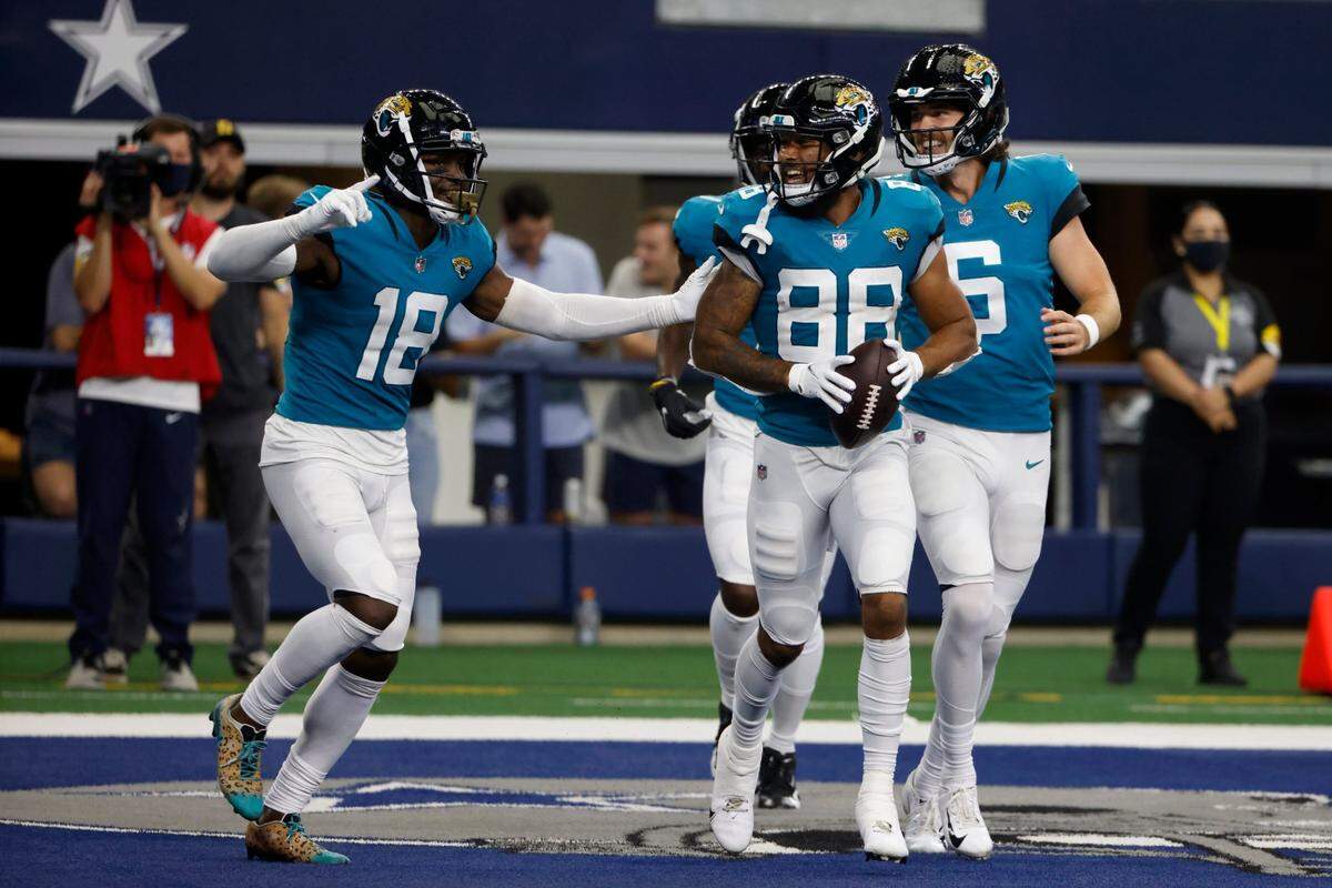 Jacksonville Jaguars’ Laquon Treadwell (18) and Jeff Cotton (88) celebrate a touchdown catch made by Treadwell in the second half of a preseason NFL football game against the Dallas Cowboys in Arlington, Texas, on Aug. 29, 2021. Cotton is a former University of Idaho football player.
