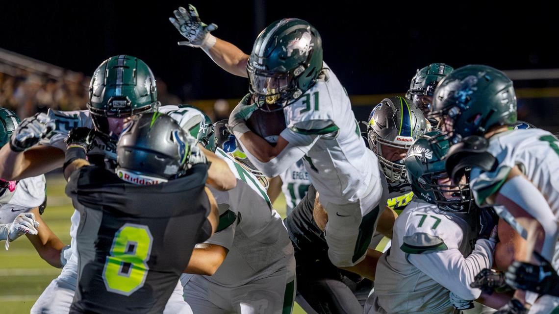 Eagle running back Noah Burnham leaps into the end zone for his third touchdown in a 28-14 win at No. 5-ranked Mountain View. The win secures No. 1 Eagle the 5A SIC River Division title and the right to host Meridian for the league championship game in two weeks.