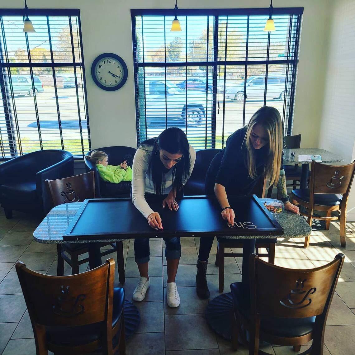 Owner Sarah Diaz, left, and friend Amanda Carpenter (a health coach and employee at The Fix) work on menu boards at the soon-to-open shake shop.