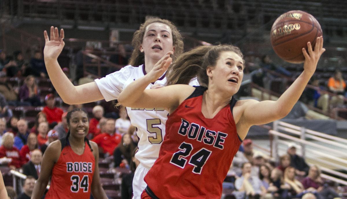 Boise senior Sarah Carrell chases down an offensive rebound with Rigby’s Tylie Jones in the first round of the State 5A girls basketball tournament Thursday, Feb. 14, 2019 at Ford Idaho Center in Nampa.