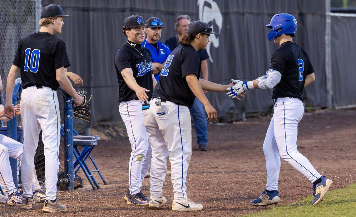 Timberline teammates greet designated hitter Eli Parker back to the dugout a hit in recent home game.