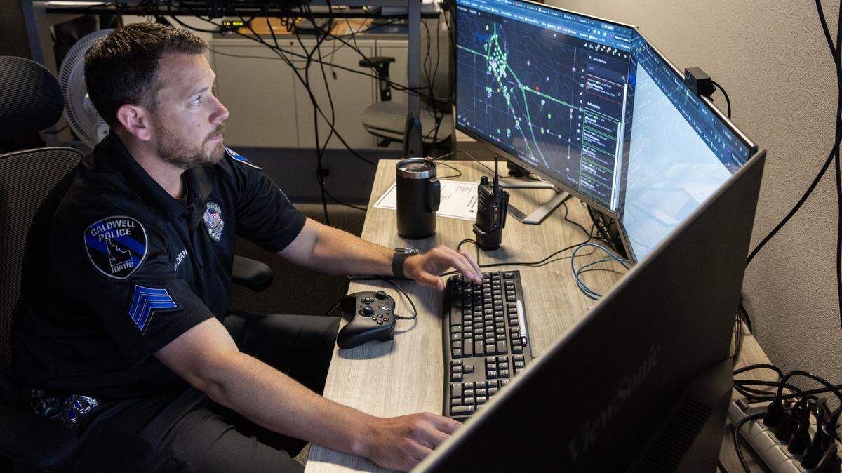Sgt. Andrew Heitzman mans the real-time information center at Caldwell Police Department, Thursday, April 16, 2026. The department is using several different AI-based technologies to do things such as write reports, view body camera footage, read license plates and send drones as first responders to emergency calls. 