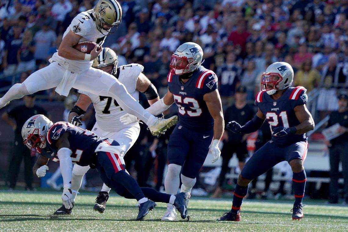 New Orleans Saints quarterback Taysom Hill hurdles New England Patriots free safety Devin McCourty during the second half of their game Sunday in Foxborough, Mass.
