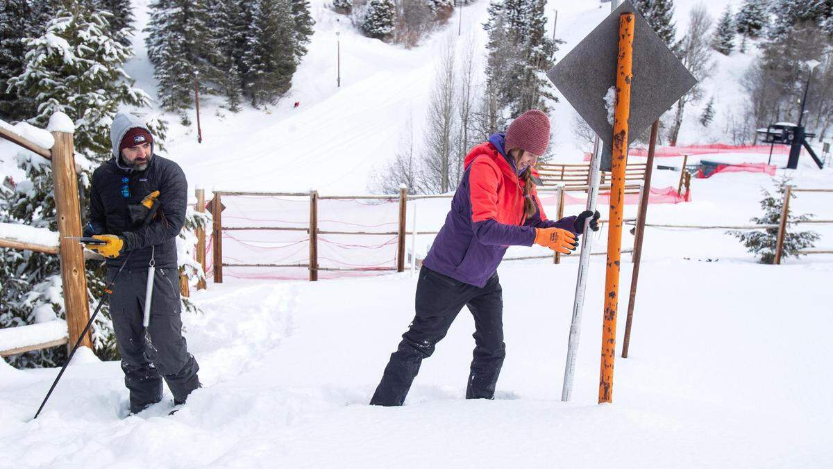 Natural Resources Conservation Service hydrologist Earl Adsley takes notes while NRCS water supply specialist Erin Whorton holds a snow-course sample at a combined SNOTEL and NRCS snow-survey site at the Bogus Basin Recreation Area in January.
