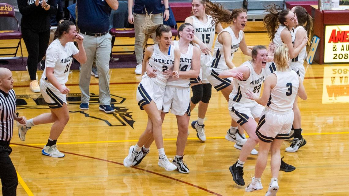 The Middleton girls basketball teams celebrates winning the 4A District Three Tournament championship with a 39-26 win over Columbia on Thursday at Columbia High School in Nampa.