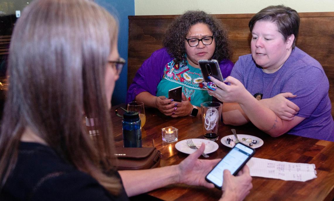 Campaign volunteer Mary Beth Nutting, left, Boise City Council District 3 candidate Lisa Sánchez, center, and campaign manager Charity Strong, right, take a look at the latest voting results late Tuesday night at Cloud 9 Brewery.