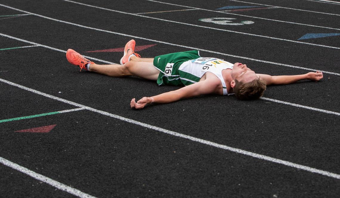 Nathan Green of Borah rests on the track after taking first place by a large gap in the 5A boys 3,200 meters at the IHSSA track and field state championships at Eagle High School on Friday, May 21, 2021. Green set the overall state meet record with a time of 8:53.47.