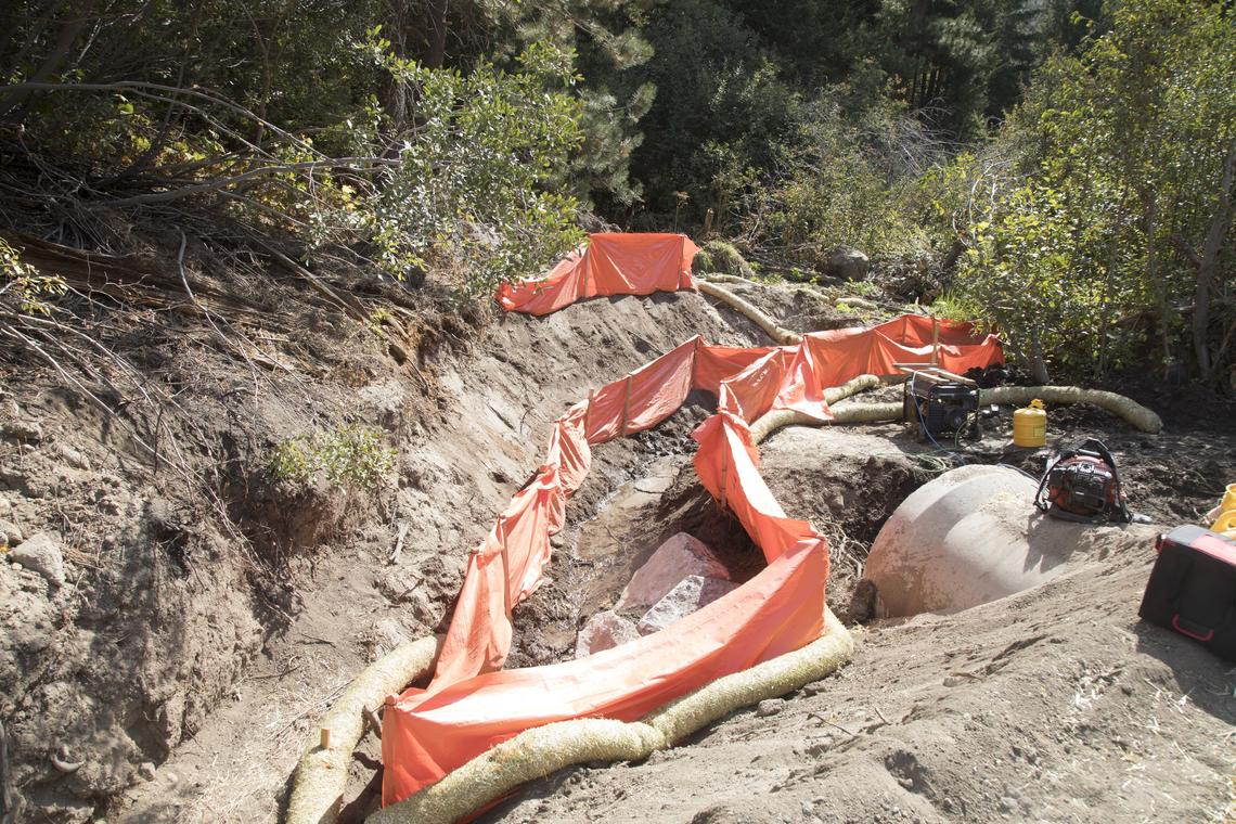 Bogus Creek, flowing through the center of the orange barrier, is a trickle at this time of the year. It carries enough water in the spring for Bogus Basin to store water for winter snowmaking.
