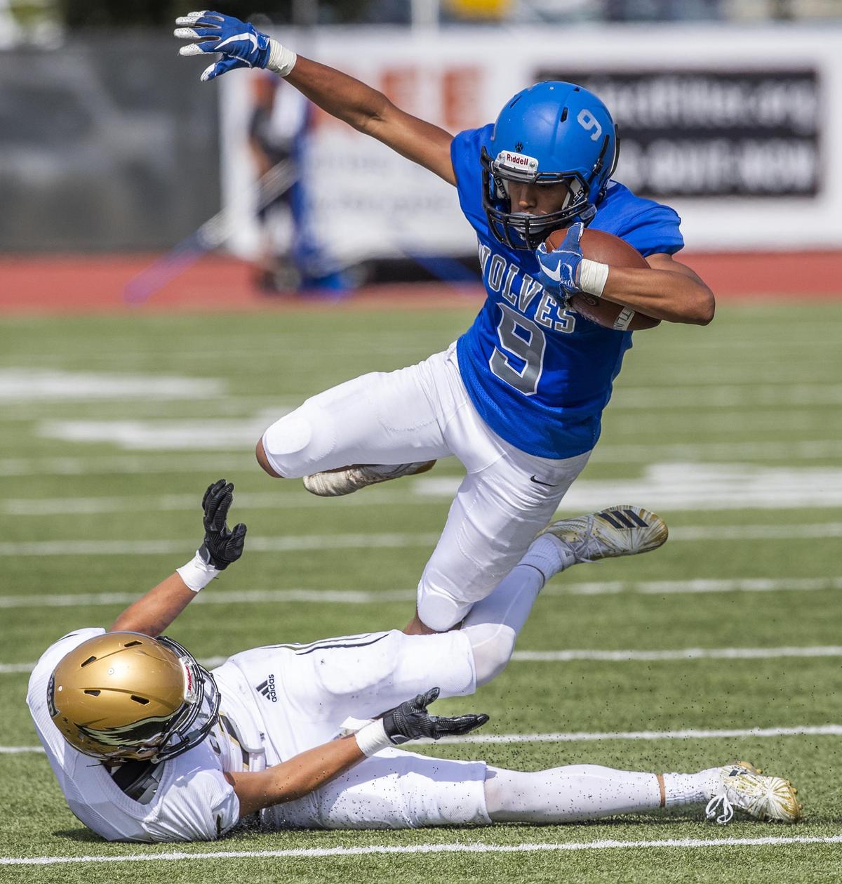 Timberline wide receiver Nicolas Caballero gets tripped up by Capital’s Cooper Leaf on Sept. 7 at Dona Larsen Park in Boise.