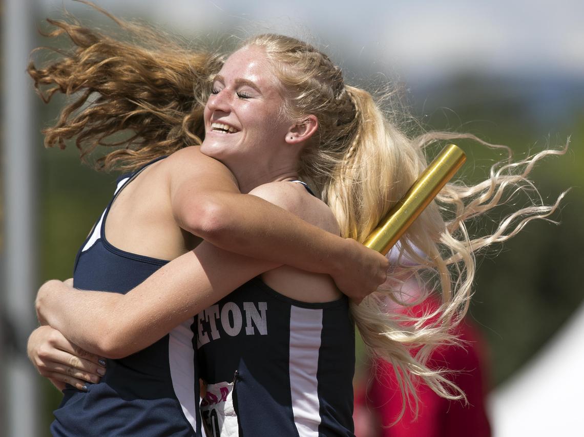Middleton junior Carlee Heindel greets 4x100 relay anchor Emmy Williams at the finish line after winning the 4A state title Saturday at Dona Larsen Park.