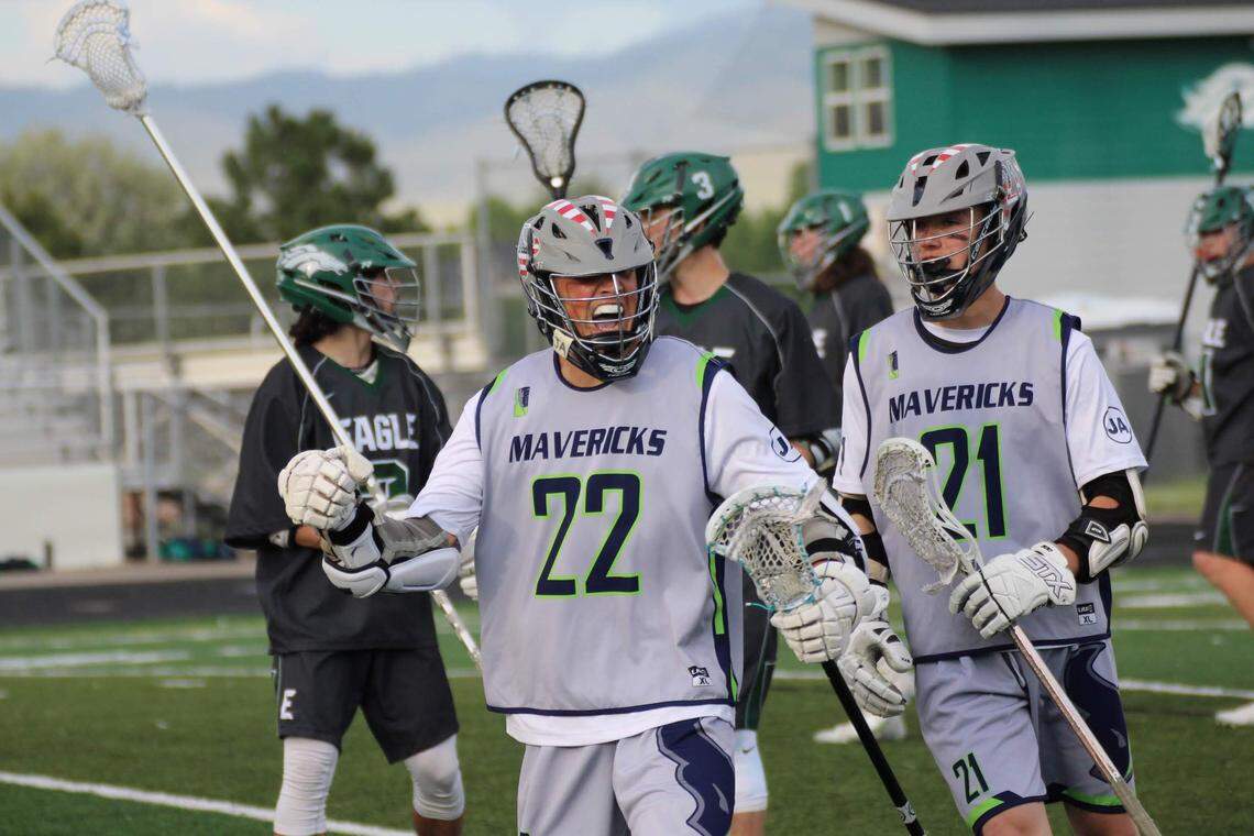 Mountain View's Ryan Henning, center, and Nicholas Hansen celebrate during the Mavericks' state championship game against Eagle.