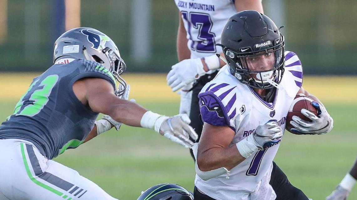 Rocky Mountain running back Jordan Erickson plows though Mountain View tacklers Friday in the Battle of the Mountains rivalry game at Mountain View.