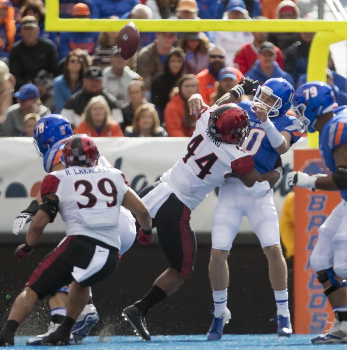 Boise State quarterback Chase Cord (10) gets hit by San Diego State linebacker Kyahva Tezino (44) as he releases the football that the Aztecs turned into an interception Saturday, Oct. 6, 2018 at Albertsons Stadium in Boise.
