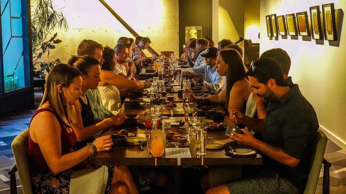 Diners enjoy a meal during a soft opening event at Kin’s new tasting room in Boise.