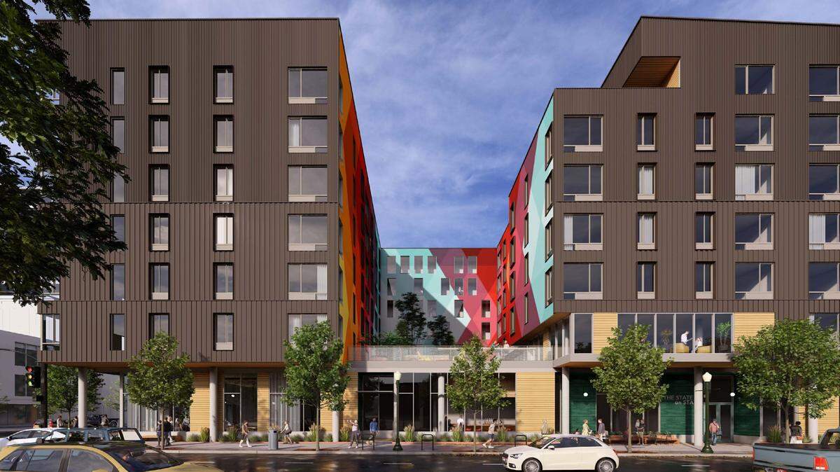 This rendering shows the proposed 7-story building from the ground floor with the green space and mural on the second floor in center.