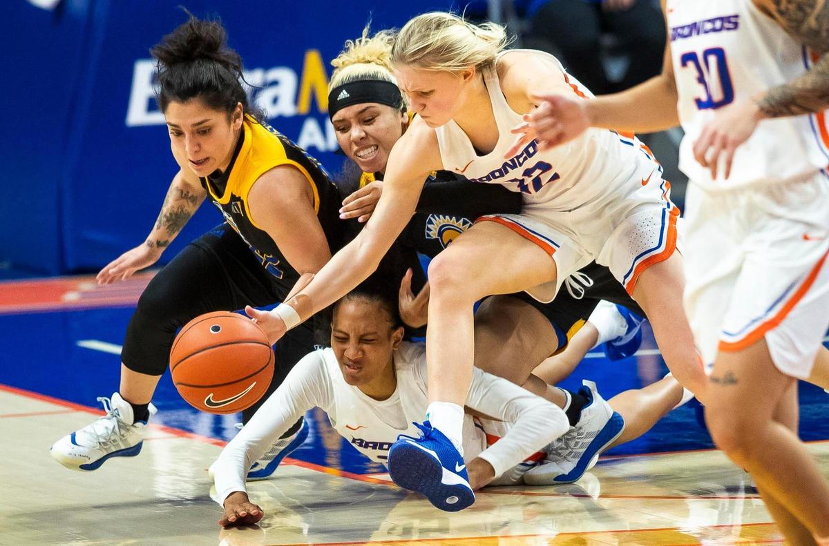 Boise State guard Mary Kay Naro and forward Alexis Mark rush to get control of the basketball against San Jose State’s Danae Marquez and Courtesy Clark in a Mountain West women’s basketball game on Dec. 31, 2020, at ExtraMile Arena in Boise.