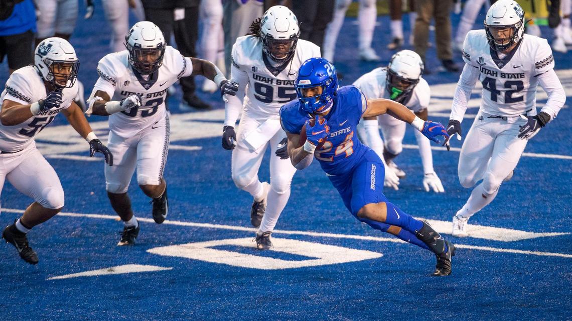 Boise State running back George Holani evades multiple Utah State defenders after catching a 17-yard touchdown pass from quarterback Hank Bachmeier in the season opener. After suffering an apparent leg injury at Air Force on Oct. 31, Holani is expected to play Saturday at Wyoming.