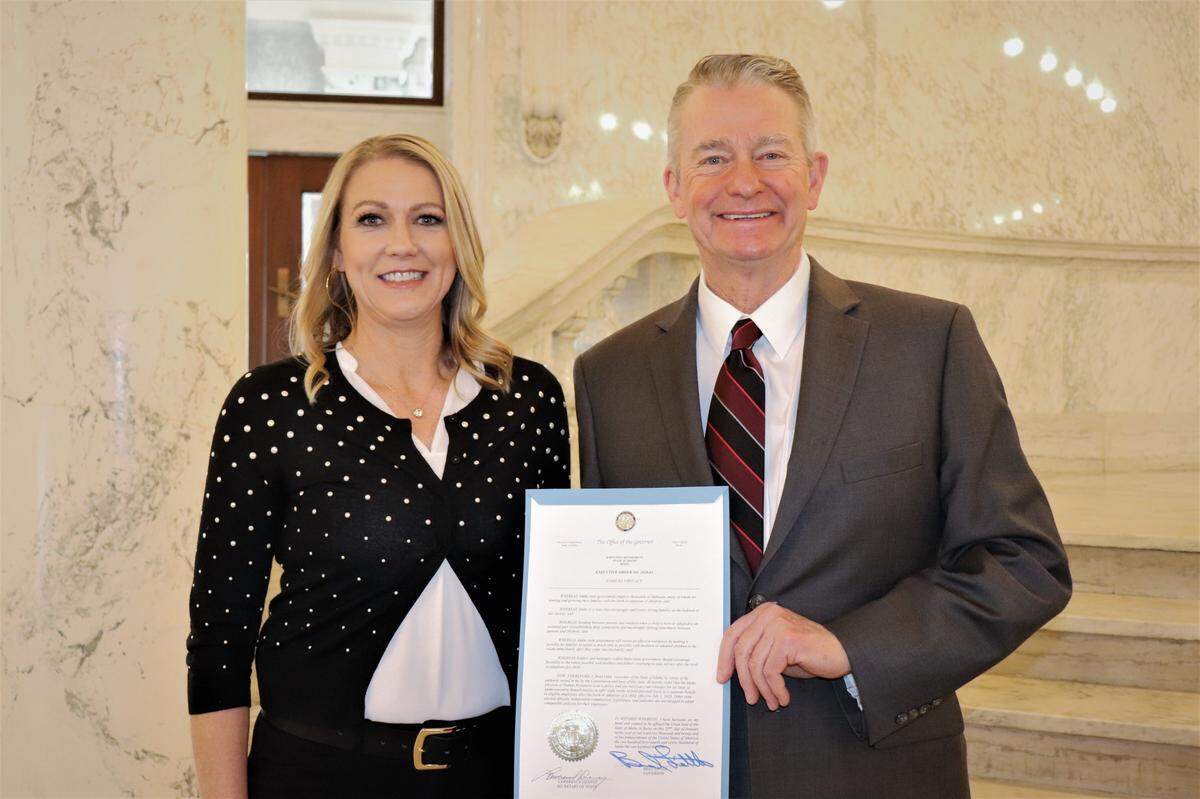 Idaho Gov. Brad Little with April Arnzen, Micron Technology Inc.’s senior vice president of human resources, after Little signed an executive order in January to grant state workers eight weeks of paid leave upon the birth or adoption of a child.