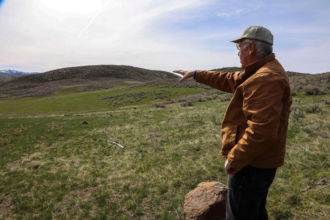 Steve Loomis, a resident and developer of Summit Ridge Ranch, shows where a proposed gun range is planned about a mile from his neighbors in the hills north of Horseshoe Bend.