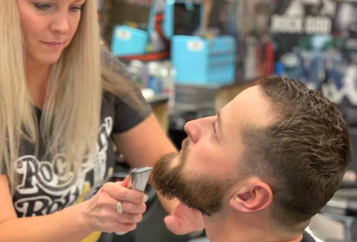 Stylist Heather Burdon trims a customer’s beard at Bolder Barbershop, a new business on Eagle Road in Eagle.