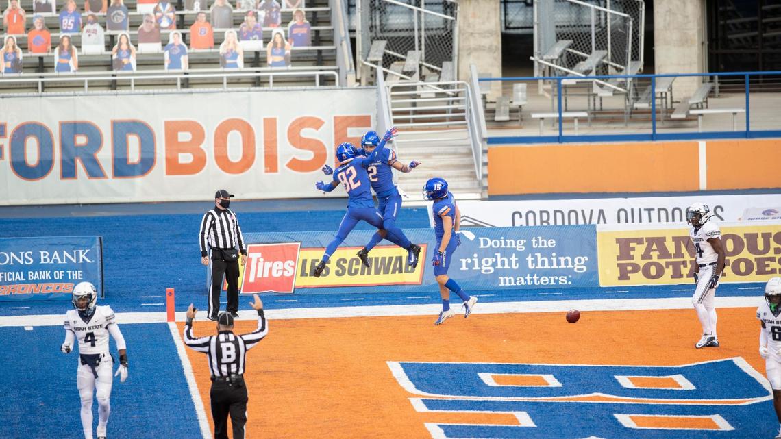 Boise State wide receiver Khalil Shakir celebrates with Stefan Cobbs after scoring a 52-yard touchdown during Saturday’s game against Utah State at Albertsons Stadium.