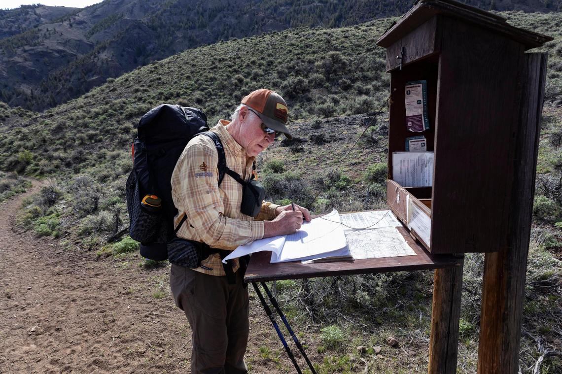 Ed Cannady signs the register for the Little Boulder Chain Lakes trail.