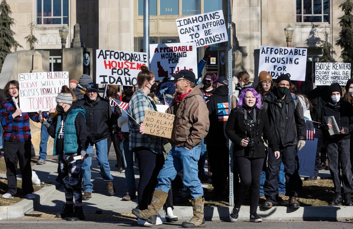 Supporters of the homeless community, as well as unhoused individuals themselves, react to a counter protest by the Idaho Liberty Dogs on Saturday, Jan. 29, 2022. For the past two weeks, homeless Idahoans with the help of volunteers have been holding a demonstration with camping tents set up on the lawn of the former Ada County Courthouse in downtown Boise.