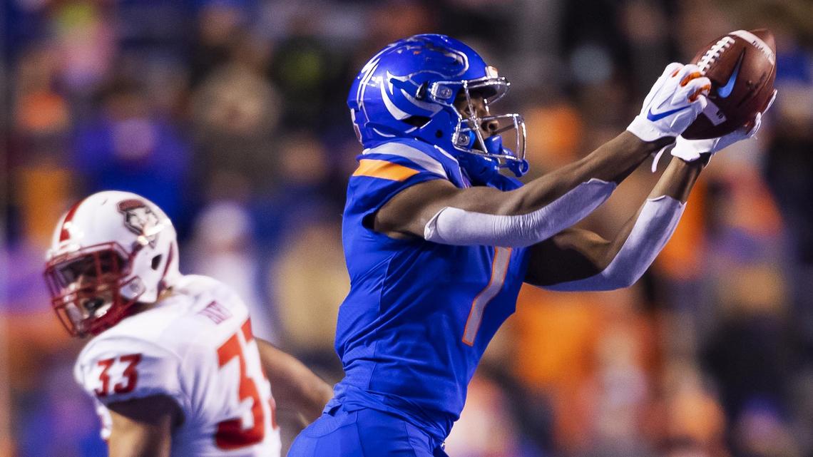 Boise State wide receiver Octavius Evans snags a pass from Jaylon Henderson with his fingertips while he’s defended by New Mexico linebacker Alex Hart on Saturday at Albertsons Stadium.