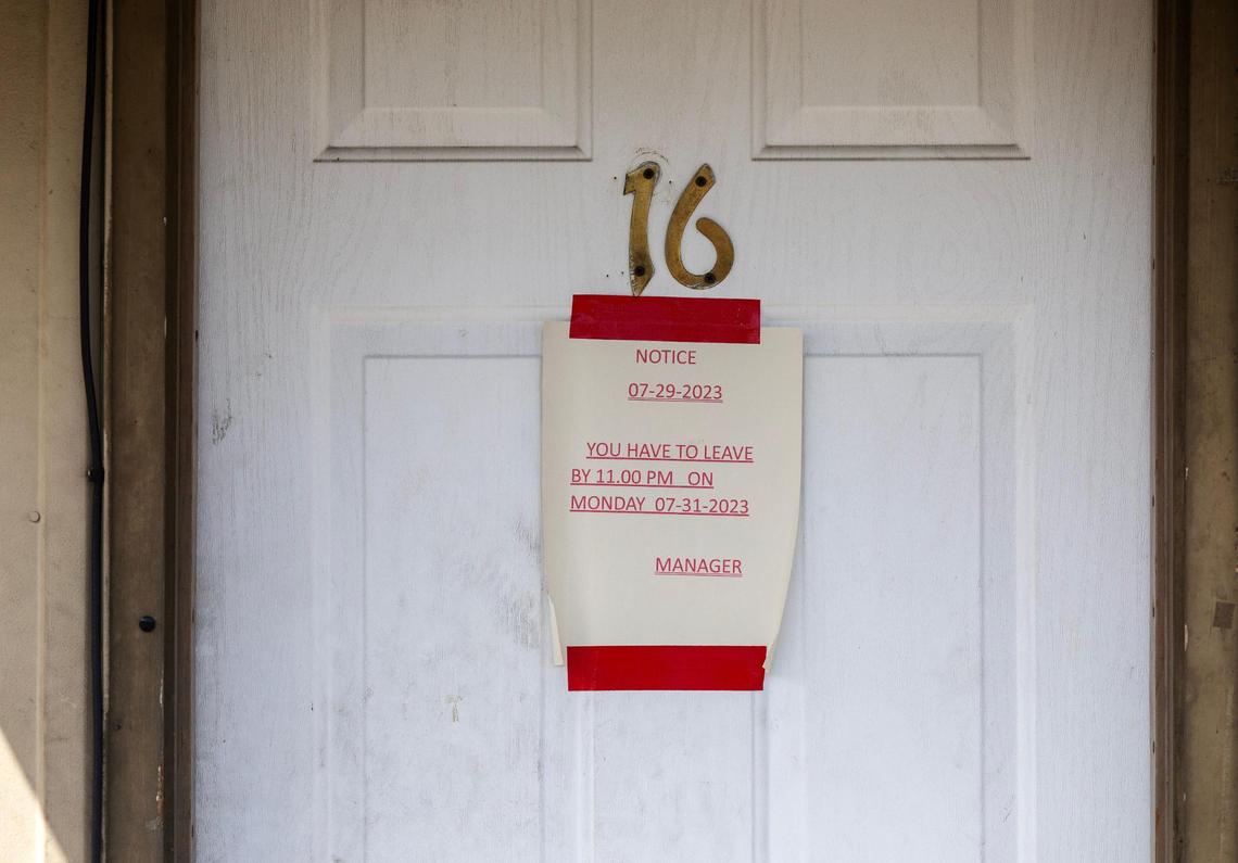 A sign on a door to a room informs a guest of the motel’s closure at 11 p.m. on July 31.