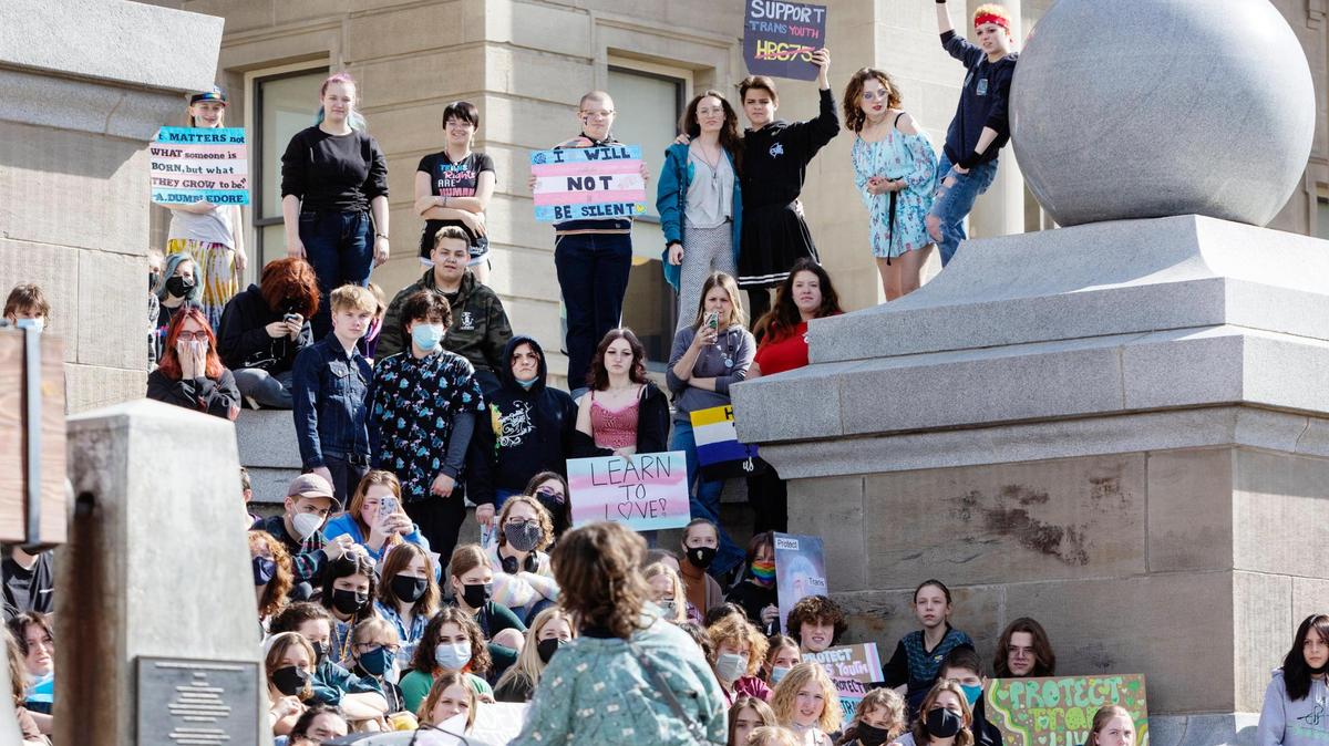 Robin Olsen speaks while people fill the steps of the Idaho Capitol Building during a rally to celebrate transgender youth in 2022. The rally came days after a bill that would criminalize gender-affirming health care for trans youth died. A similar bill has been introduced this year