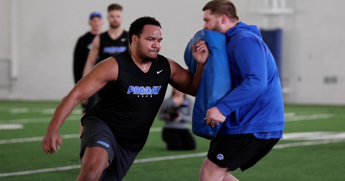 Former Boise State offensive lineman John Ojukwu blocks through a drill at Pro Day, where NFL scouts measured, weighed and drilled Broncos hoping for a shot at professional football, Monday, March 27, 2023.