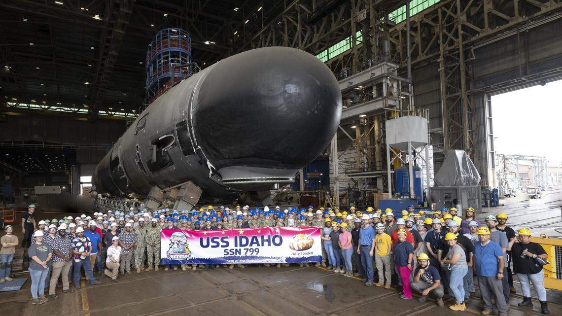 The USS Idaho crew and Electric Boat employees pose for a photo with the future USS Idaho in October 2023. The USS Idaho is four stories tall, four stories wide and 377 feet long. The nuclear submarine was delivered to the U.S. Navy in December 2025 and is expected to be commissioned in spring 2026.