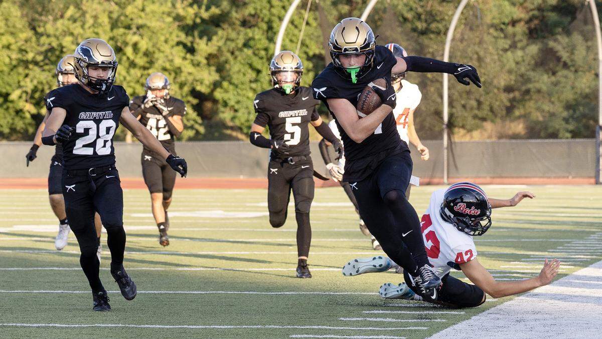 Capital wide receiver junior Elliot Schrack moves the ball forward during their game against Boise at Dona Larsen Park, Thursday, Aug. 28, 2025.