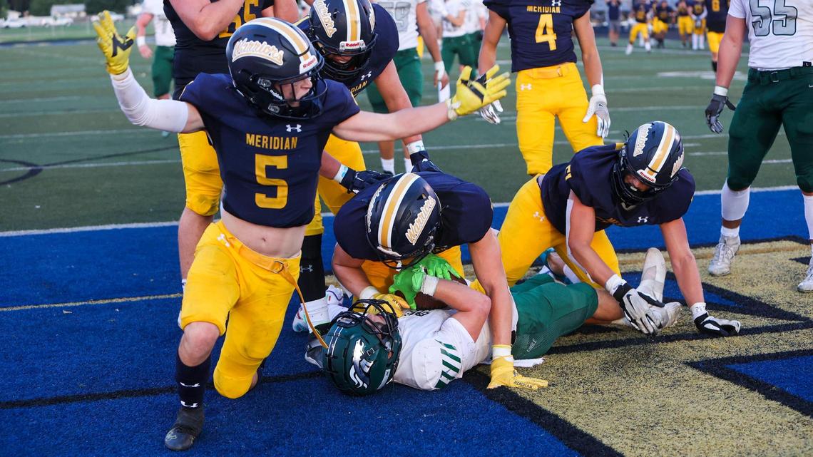 Meridian cornerback Mason Mayer celebrates as the Warrior defense scores a safety against Eagle in a season-opening game Friday at Meridian High School.