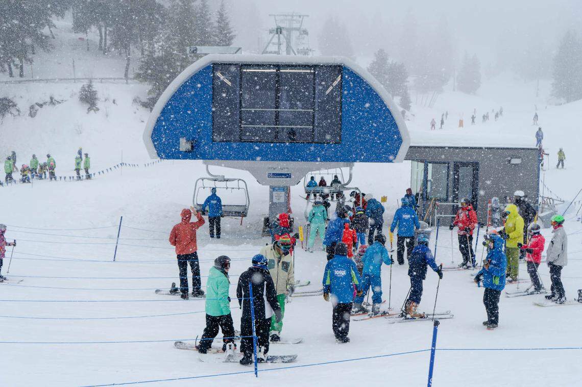 Skiers and snowboards gather at the Morning Star Express chairlift terminal at Bogus Basin.